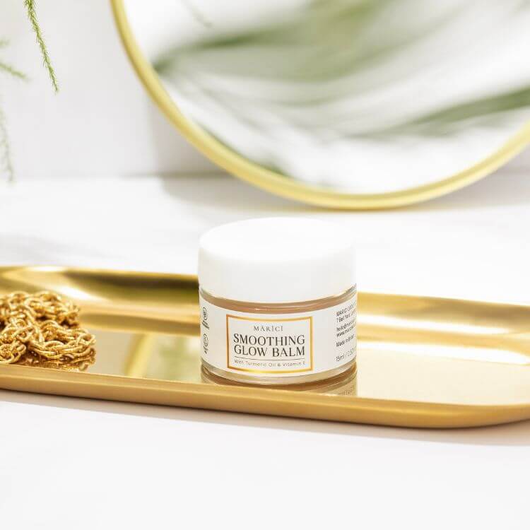 Skin Renewal & Repair Balm in a stylish jar on a gold tray, showcasing its multipurpose skincare qualities.